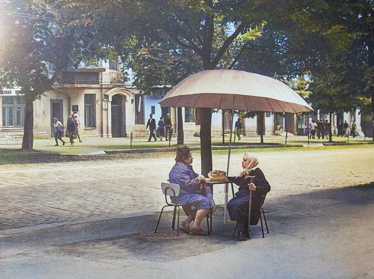 Elderly ladies under an umbrella